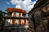 Chiang Mai - Wat Lam Chang, the Ubosot with the Ho Trai (library), at the side an old ruined Chedi.